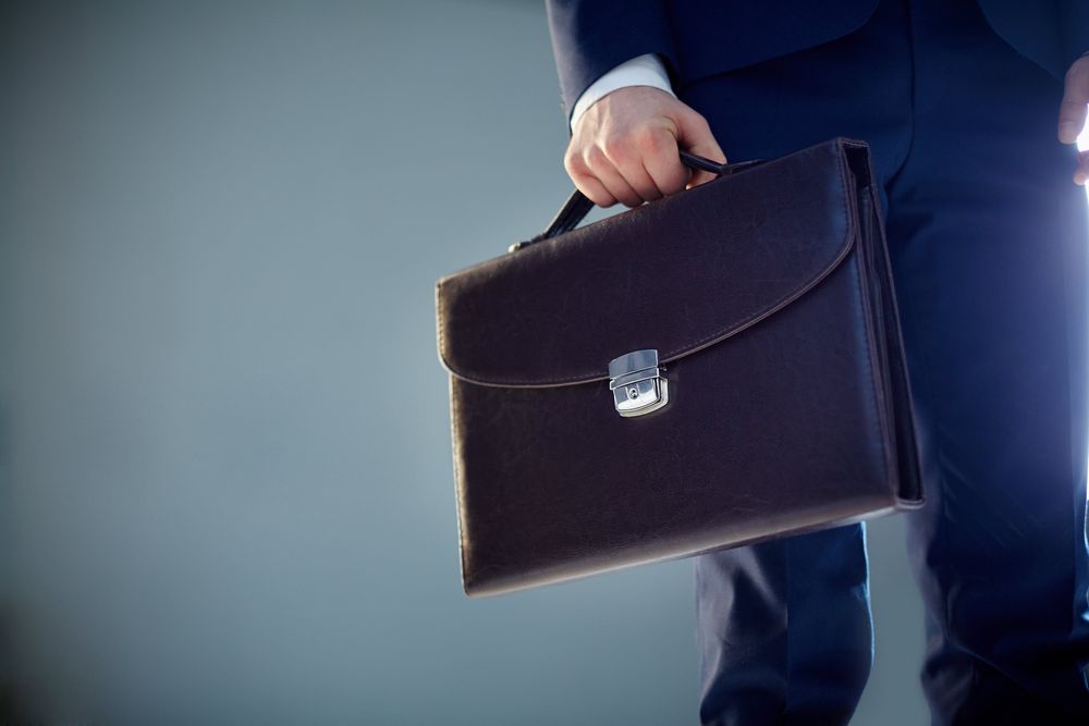 isolated-image-of-a-businessman-carrying-a-briefcase-SBI-300726244.jpg